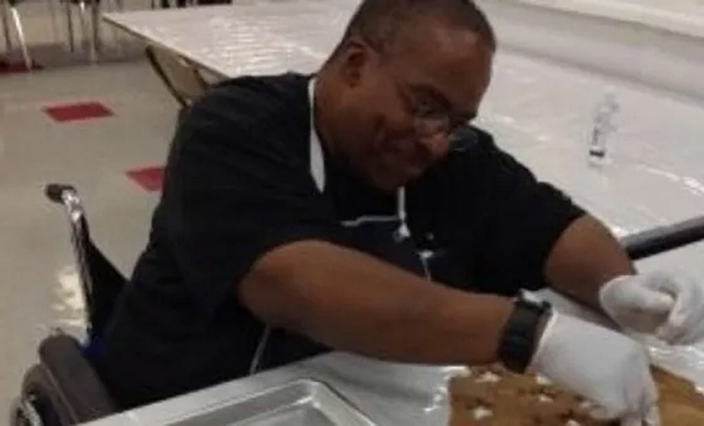 man cutting out cookies