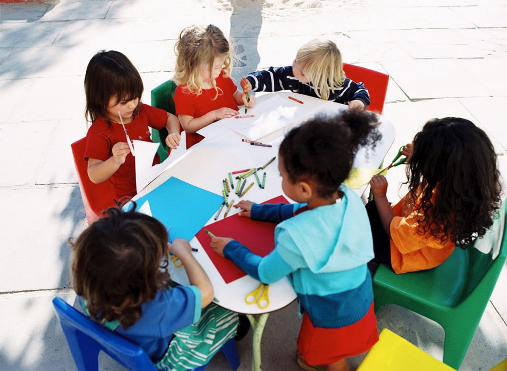 group of children coloring in a school setting