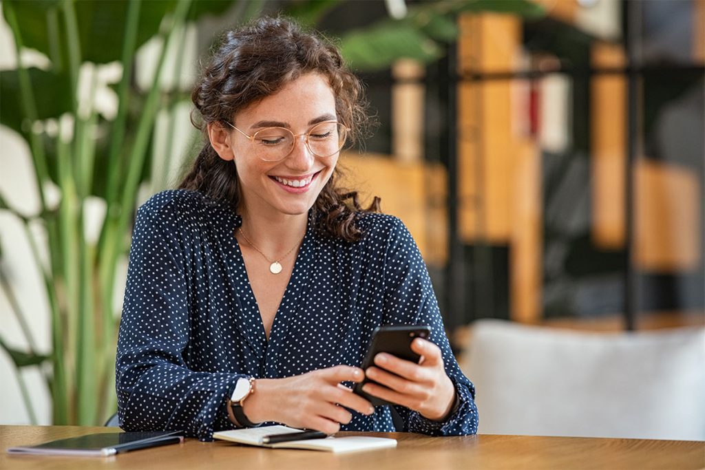 woman smiling at phone